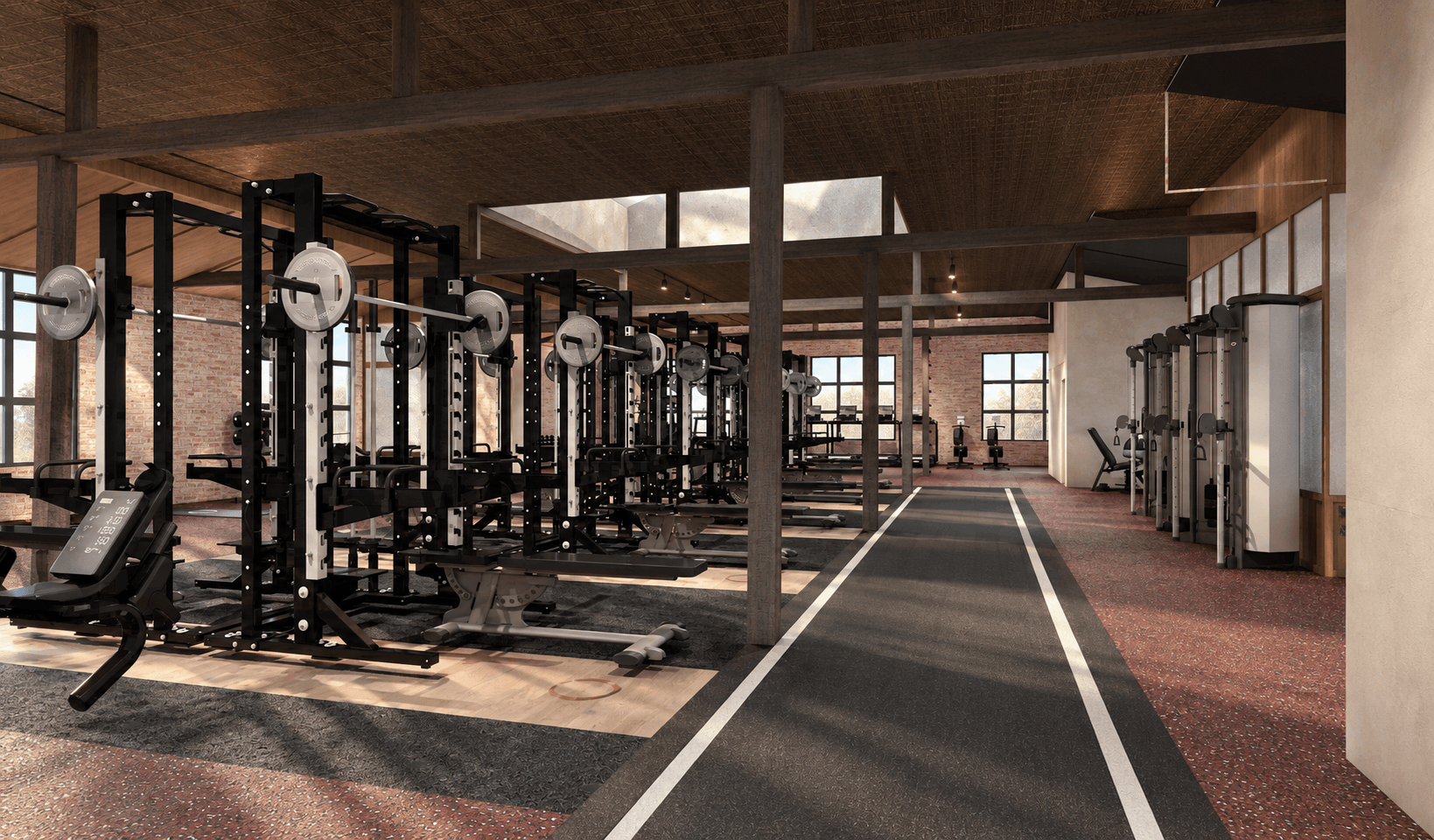 A gym floor with red floor, lifting platforms and squat rack